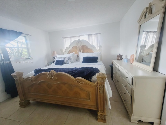 bedroom featuring light tile floors