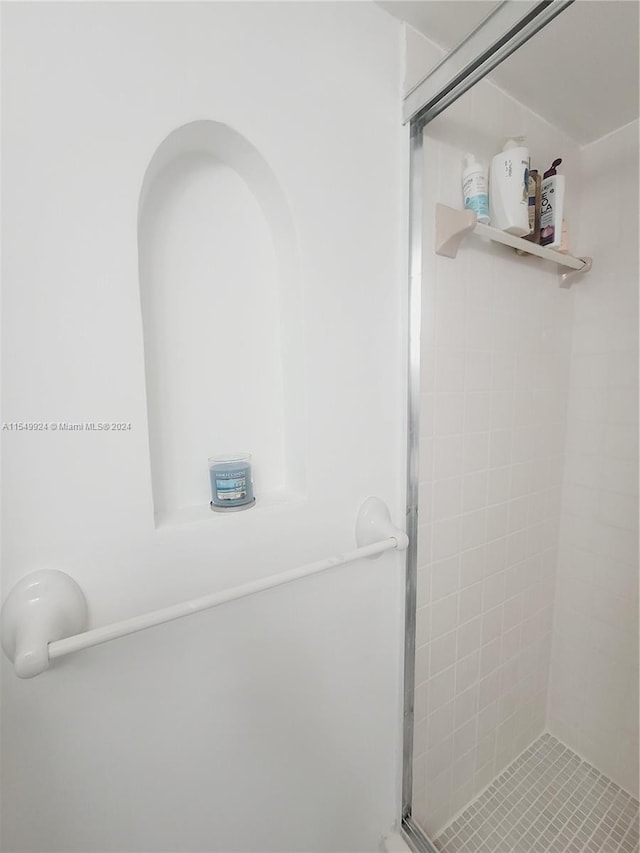 bathroom featuring a shower with shower door