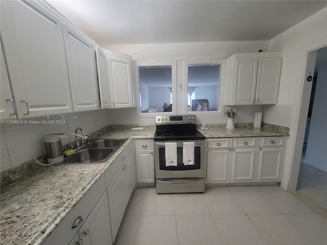 kitchen with light tile flooring, sink, white cabinets, stainless steel range with electric stovetop, and light stone counters