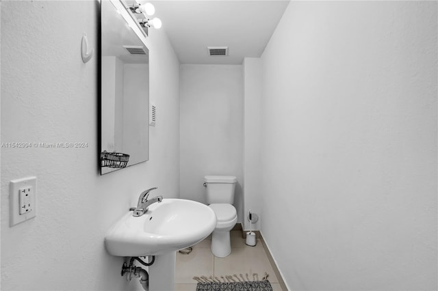 bathroom with sink, tile flooring, and toilet