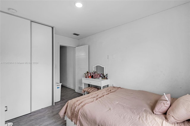 bedroom featuring a closet and dark wood-type flooring