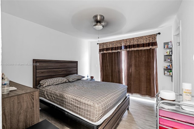 bedroom with ceiling fan and light wood-type flooring