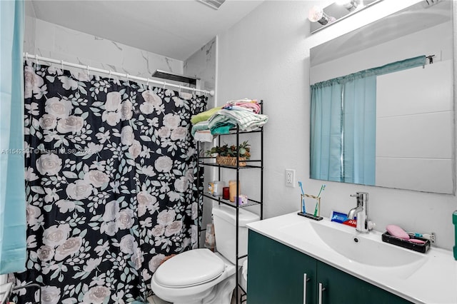 bathroom with toilet and vanity