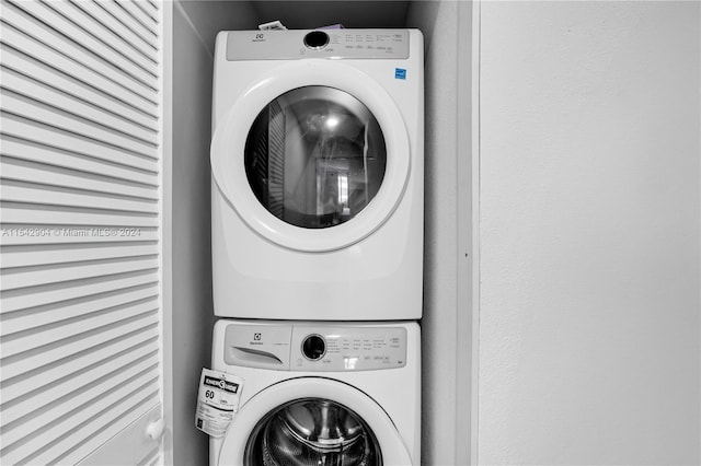 washroom featuring stacked washer / dryer