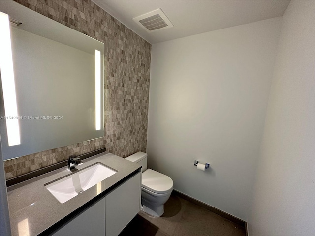 bathroom featuring tile walls, toilet, tile floors, tasteful backsplash, and vanity