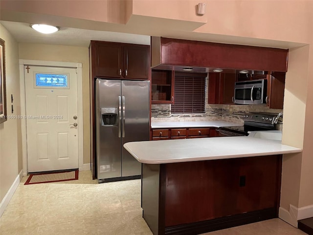 kitchen featuring backsplash, kitchen peninsula, and appliances with stainless steel finishes