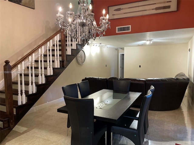 dining room featuring a towering ceiling and an inviting chandelier