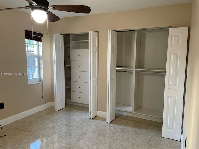 unfurnished bedroom with two closets and ceiling fan