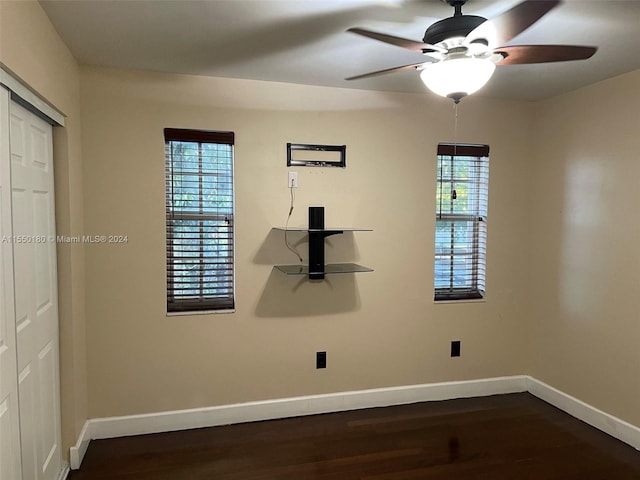 spare room with dark hardwood / wood-style floors and ceiling fan