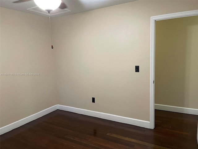 empty room with ceiling fan and dark hardwood / wood-style flooring