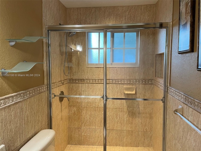 bathroom with an enclosed shower and toilet