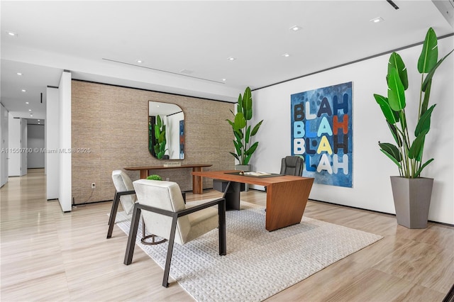 office with light wood-style flooring and recessed lighting