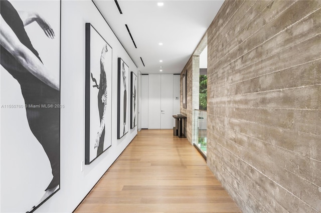 corridor with recessed lighting and light wood-style flooring