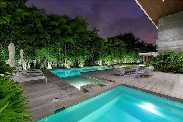 outdoor pool featuring an in ground hot tub and an outdoor living space