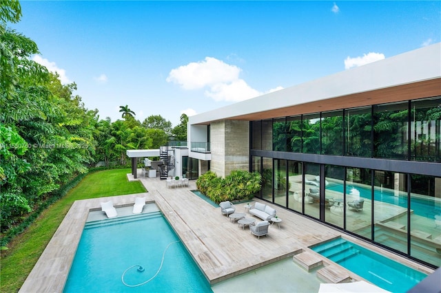 pool with an in ground hot tub and a lawn