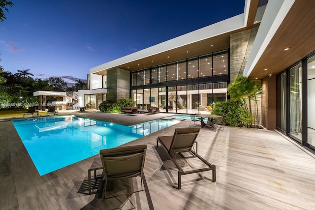 view of pool with a pool with connected hot tub, stairway, and a patio