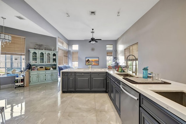 kitchen with ceiling fan with notable chandelier, a healthy amount of sunlight, light tile floors, and dishwasher