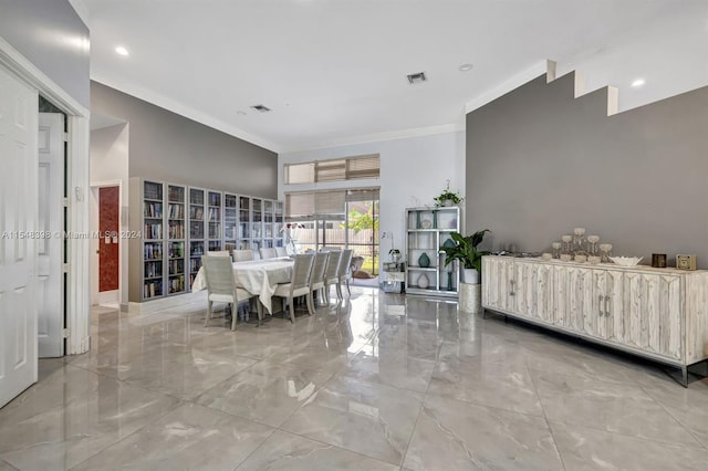 dining room featuring ornamental molding and light tile flooring