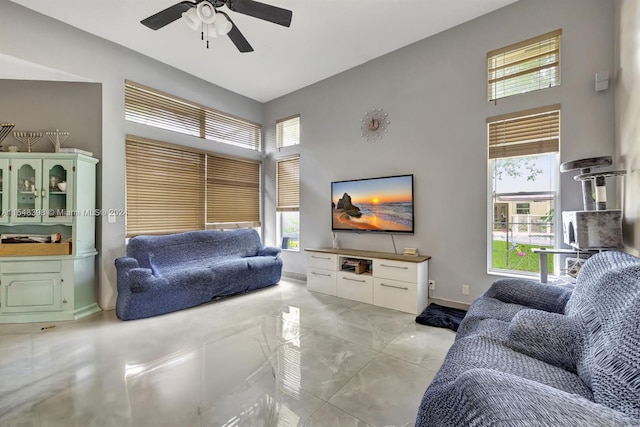 living room with light tile floors and ceiling fan