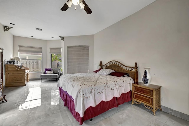 tiled bedroom featuring ceiling fan