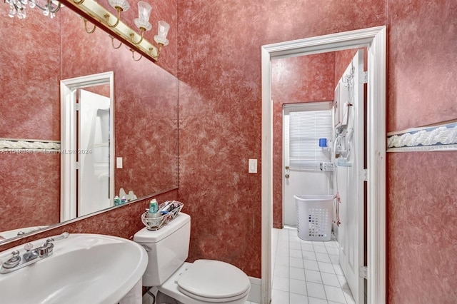 bathroom with sink, tile flooring, and toilet