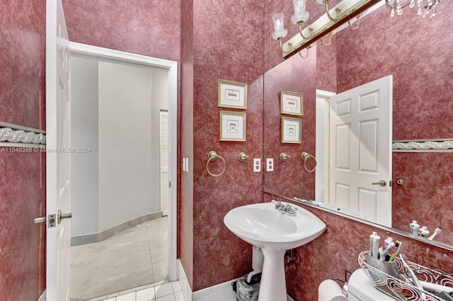 bathroom featuring toilet and tile floors