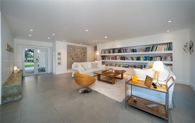 living room featuring tile patterned flooring, built in features, and french doors