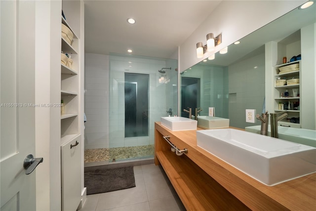 bathroom featuring vanity, tile patterned flooring, and a shower