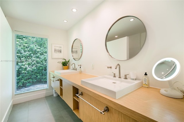 bathroom featuring tile patterned floors, vanity, and a healthy amount of sunlight