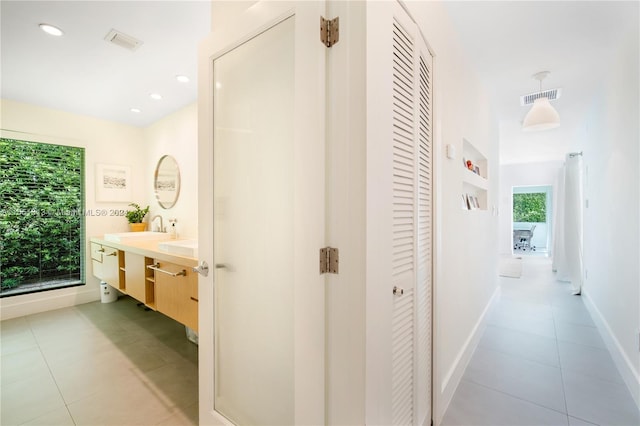 bathroom featuring plenty of natural light, vanity, and tile patterned flooring