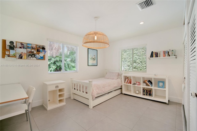 bedroom featuring light tile patterned floors