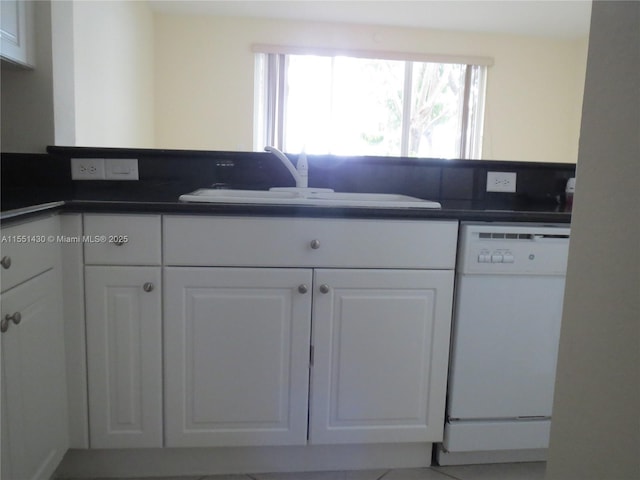 kitchen featuring sink, white cabinets, and white dishwasher