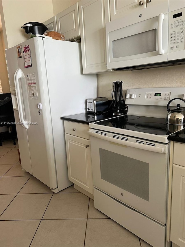 kitchen featuring white appliances and light tile patterned floors