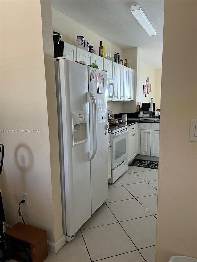 kitchen featuring white cabinetry, white appliances, and light tile patterned floors