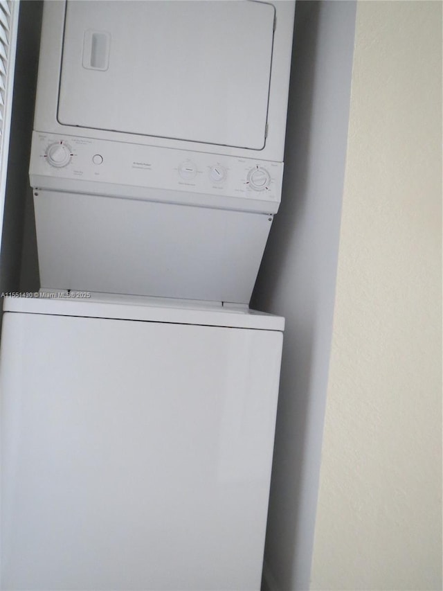 laundry area with stacked washer and dryer