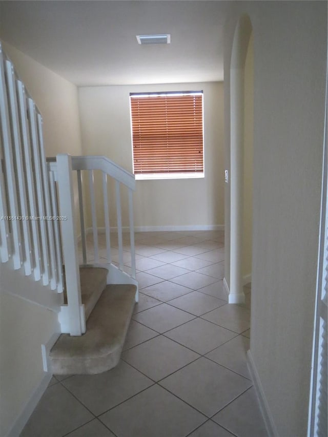 staircase with tile patterned floors