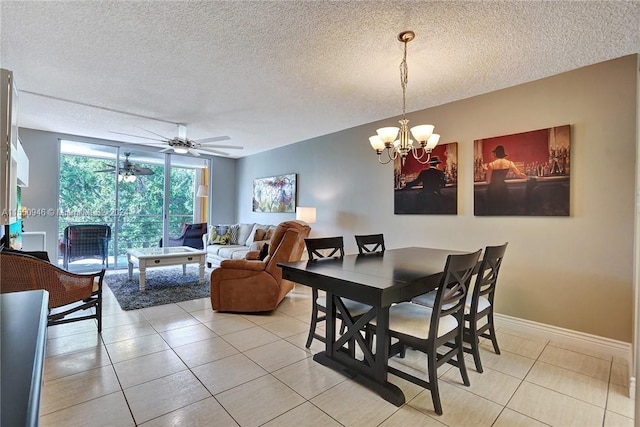 dining space featuring ceiling fan with notable chandelier, baseboards, light tile patterned flooring, and a textured ceiling