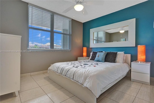 tiled bedroom featuring ceiling fan