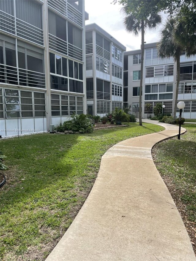 view of home's community with a lawn