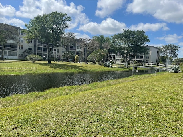 view of property's community featuring a water view and a lawn