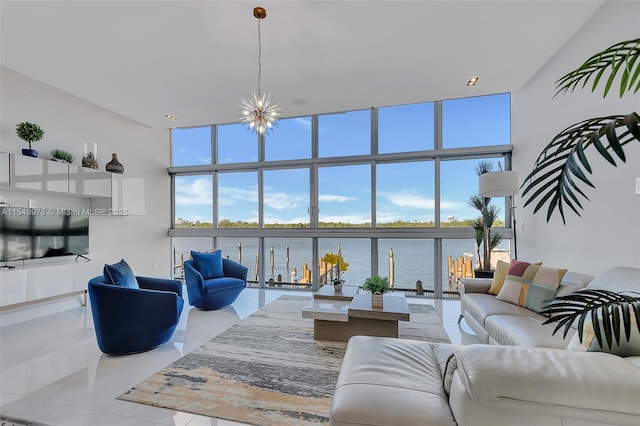 living room with a water view, floor to ceiling windows, and a wealth of natural light