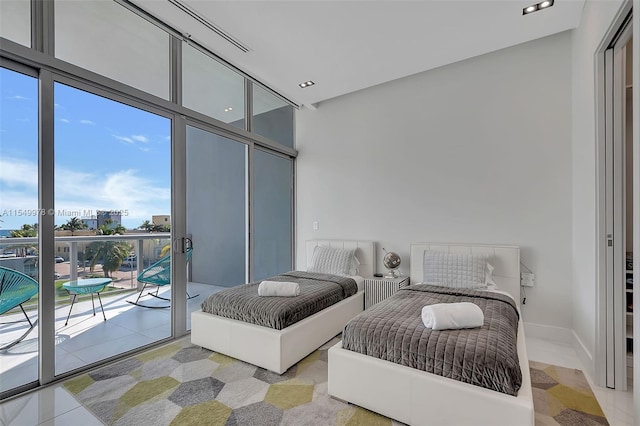 bedroom with access to exterior, light tile patterned floors, and floor to ceiling windows