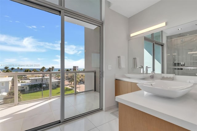 bathroom with tile patterned flooring, vanity, and a shower with shower door