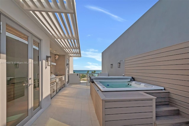 view of patio with a pergola, a covered hot tub, and a water view