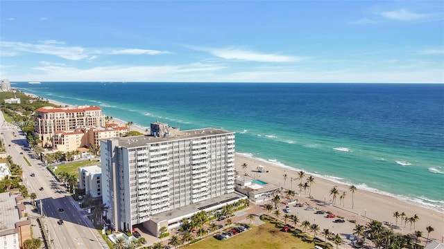 aerial view with a water view and a beach view