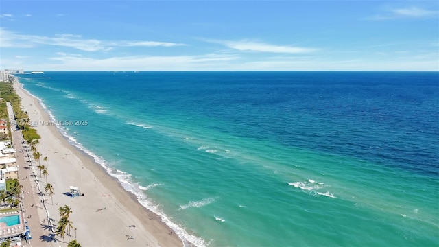 birds eye view of property with a water view and a view of the beach