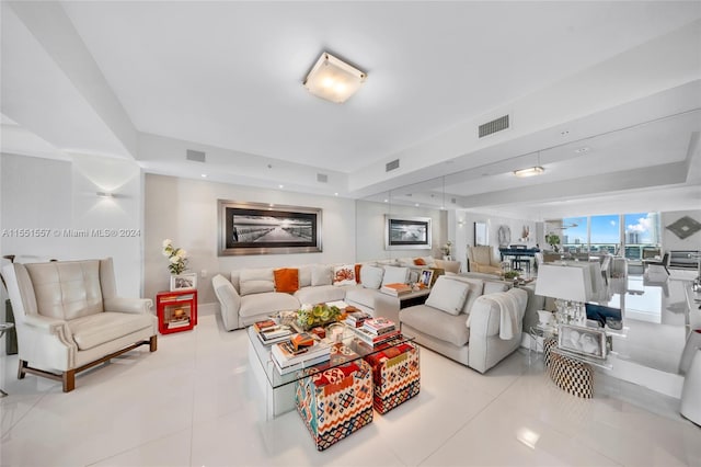 tiled living room with a raised ceiling