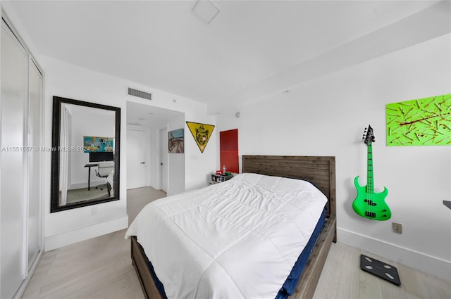 bedroom with a closet and light wood-type flooring