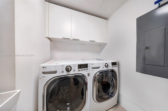 laundry area with washer and clothes dryer and cabinets