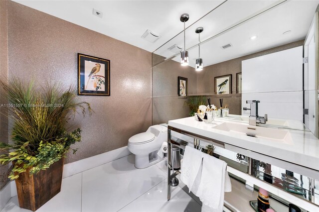 bathroom featuring toilet and vanity